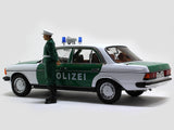 1980 Mercedes Benz 200 Polizei with Figure 1:18 Norev dealer edition scale model.